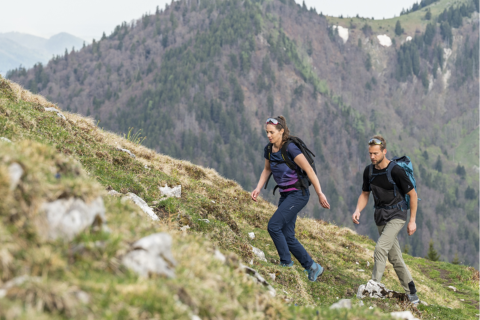 Man and woman hiking up a hill
