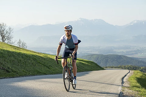 Man riding a road bike with singlet on