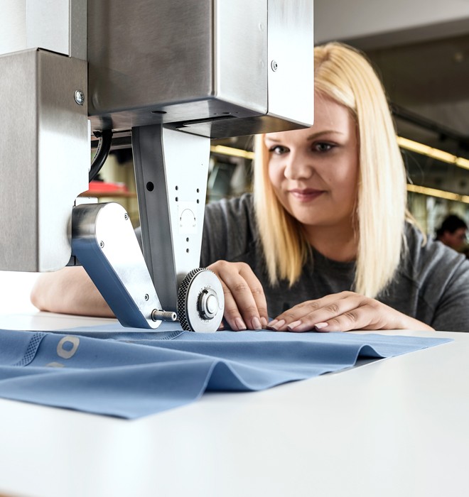 Woman working on hotBOND machine.