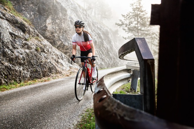 Woman riding a bike uphill.