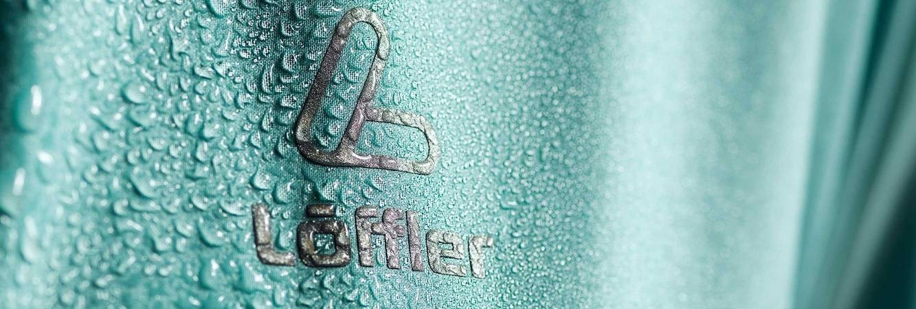 Löffler Logo on fabric with water drops.