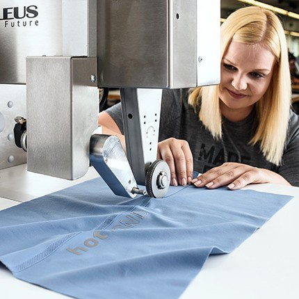 Woman working on hotBond machine.