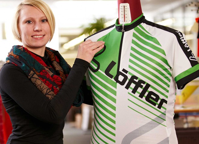 Woman presenting Löffler jersey.