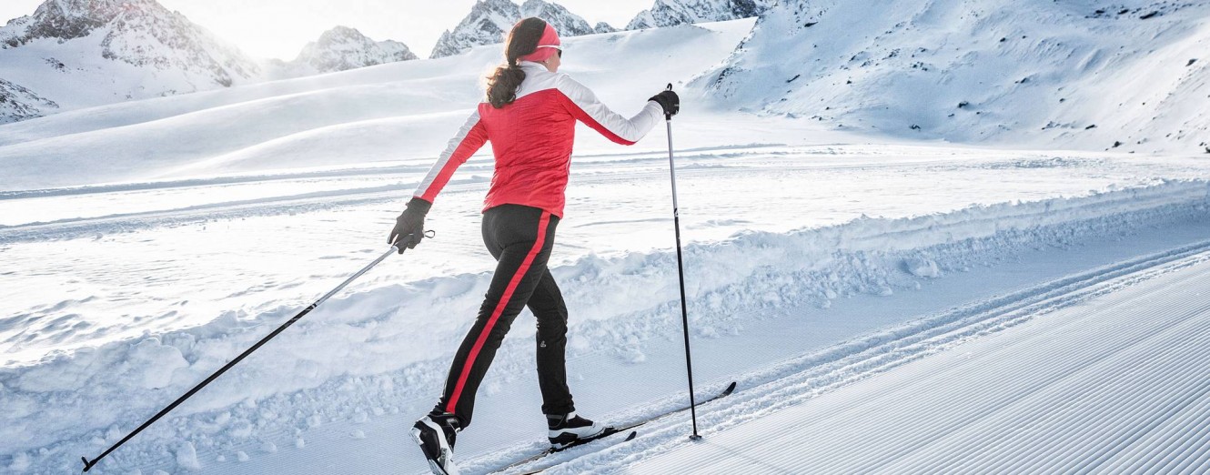 Woman cross country skiing with pink jacket